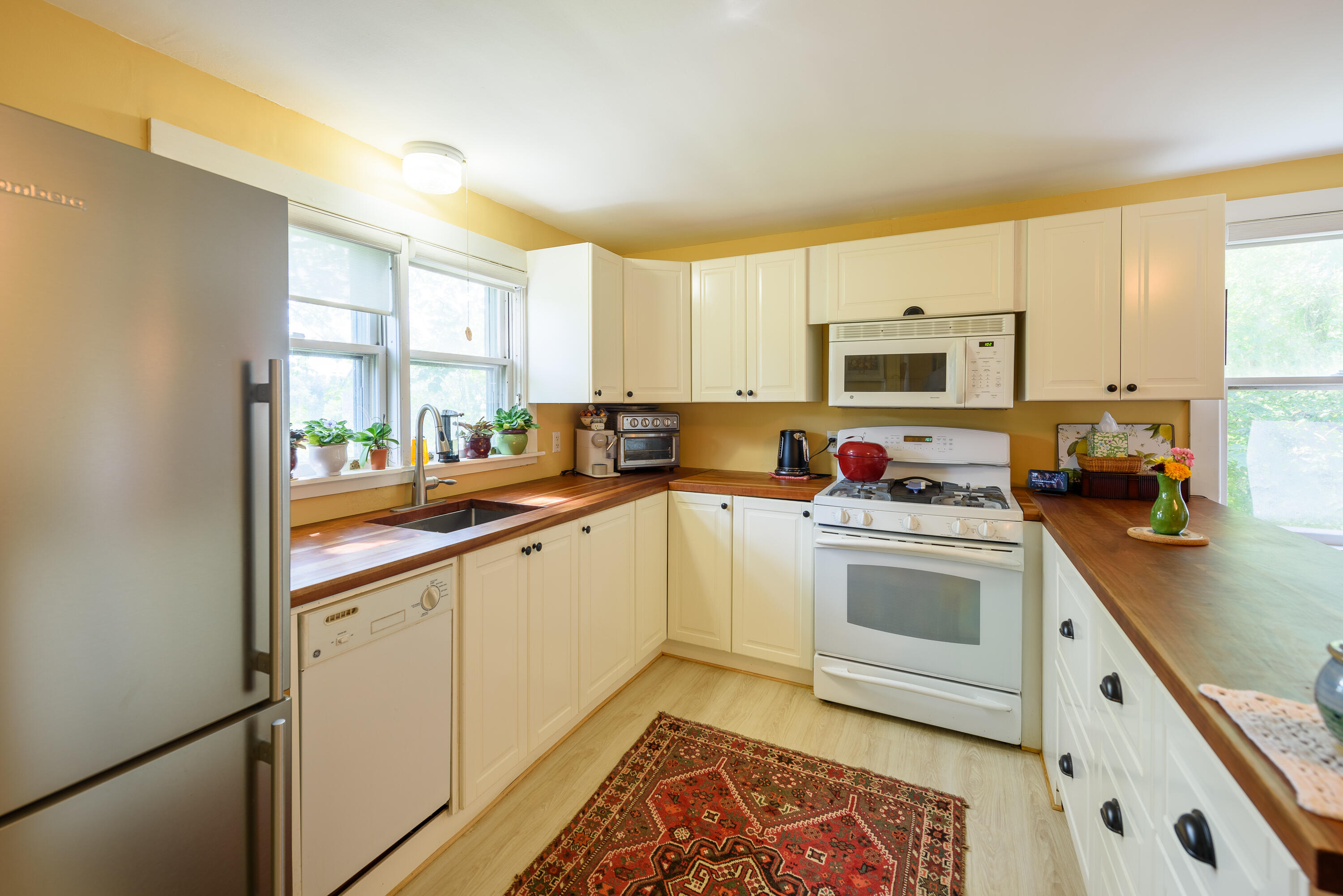 90 West Tisbury Road Edgartown, MA 02539 - Photo 22 of 46 a kitchen with granite countertop a sink a counter top space appliances and cabinets