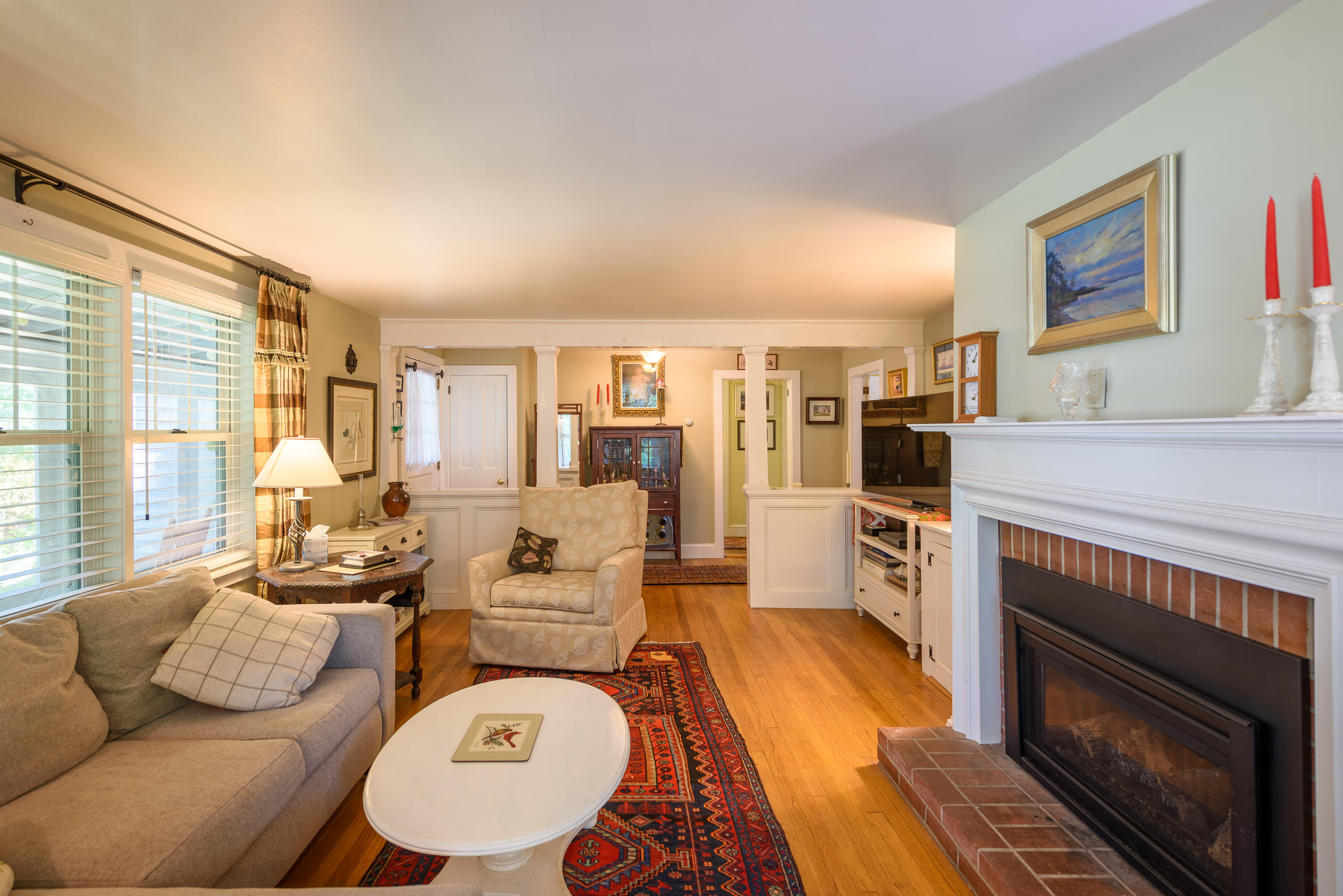 90 West Tisbury Road Edgartown, MA 02539 - Photo 27 of 46 a living room with furniture a large window and a fireplace