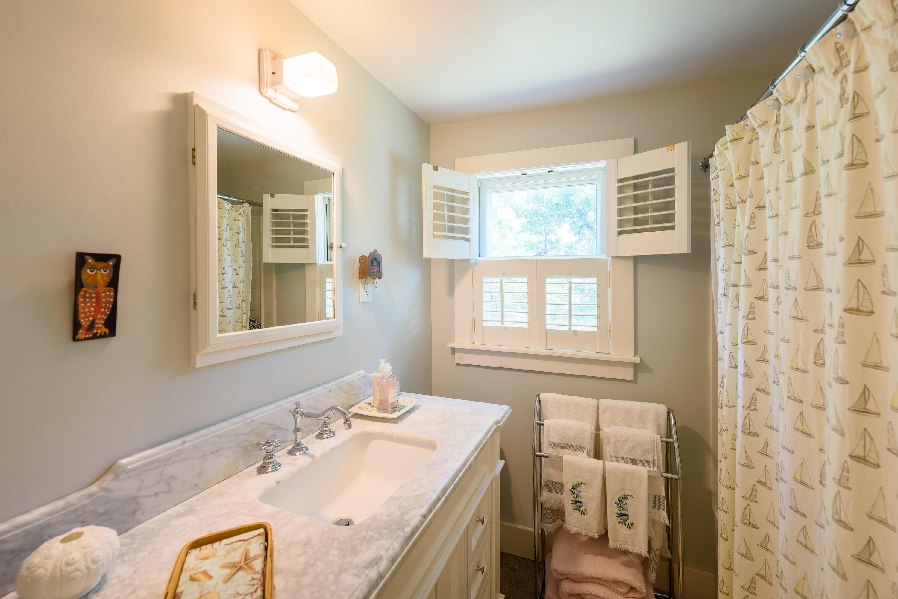 90 West Tisbury Road Edgartown, MA 02539 - Photo 31 of 46 a bathroom with a granite countertop sink a large mirror and a window