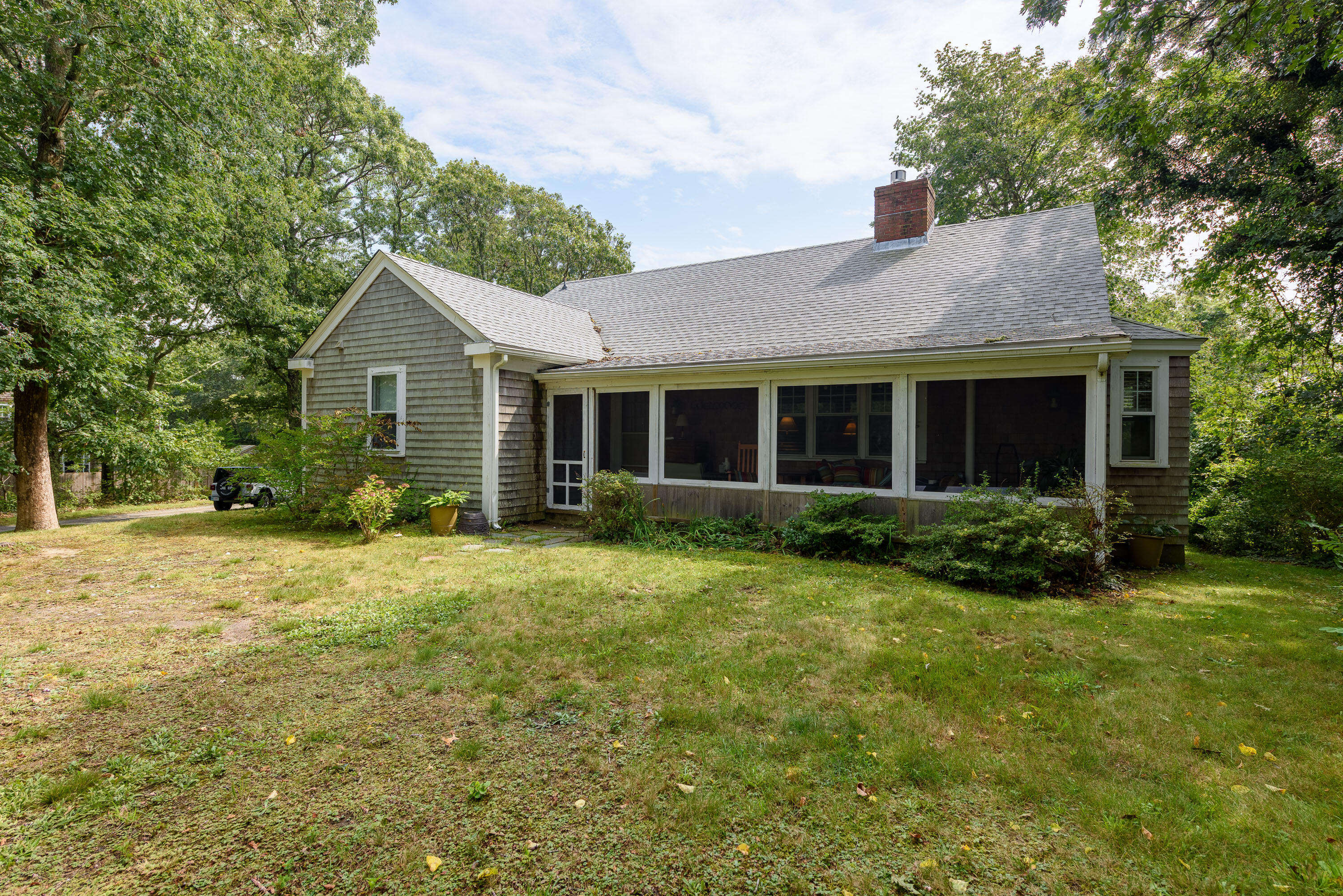 90 West Tisbury Road Edgartown, MA 02539 - Photo 40 of 46 a front view of a house with a yard and garage