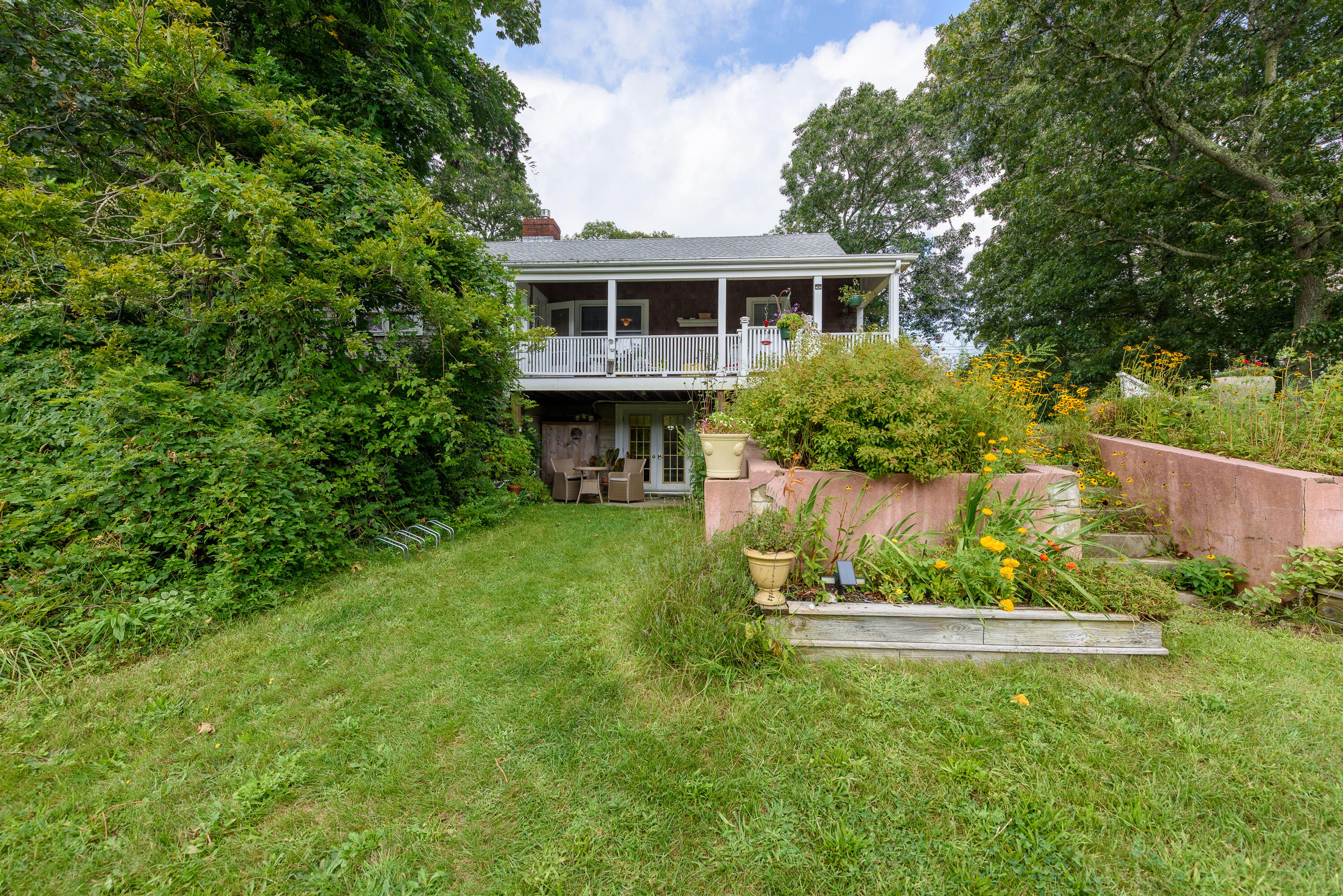 90 West Tisbury Road Edgartown, MA 02539 - Photo 42 of 46 a aerial view of a house with a yard table and chairs