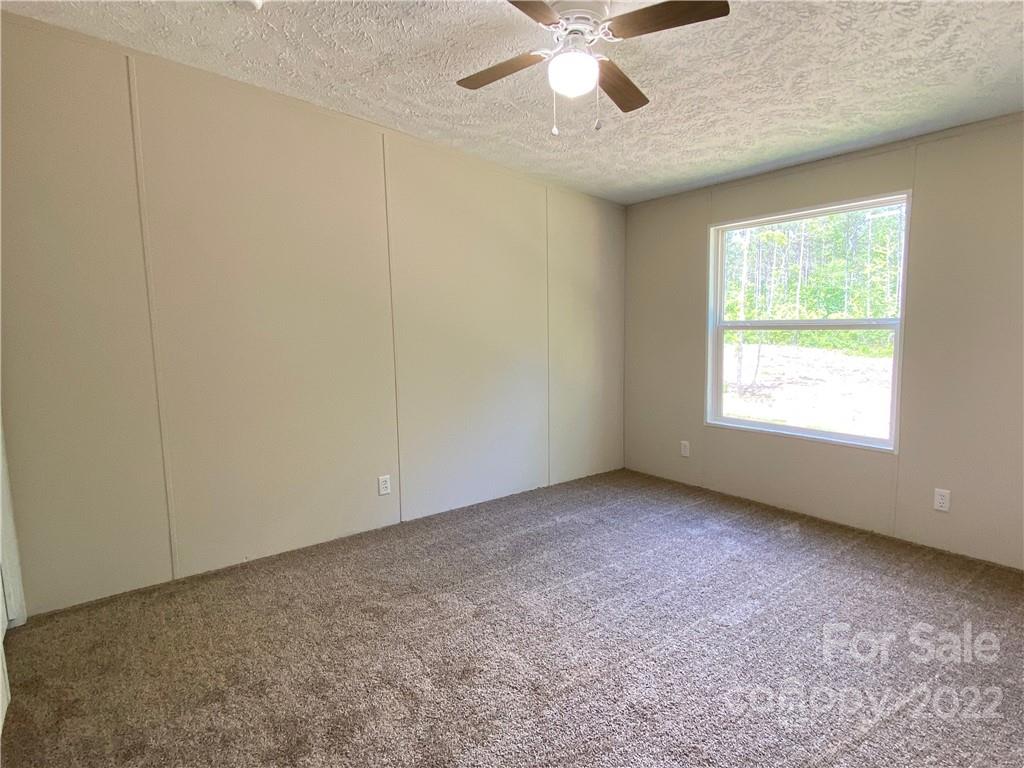 187 Mosley Road Blacksburg, SC 29702 - Photo 14 of 16 an empty room with a window and a fan
