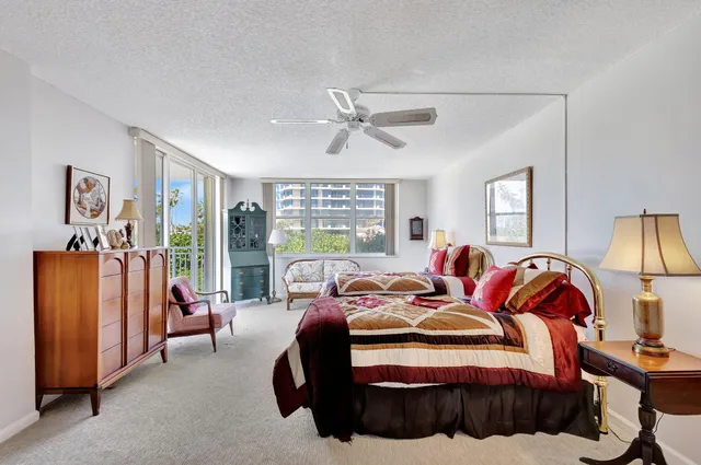 a bedroom with a bed and large window