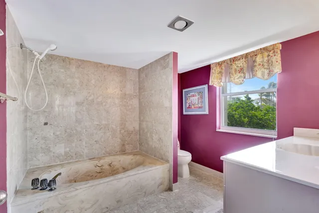 a en suite bathroom with a sink vanity and mirror