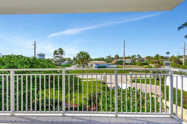 a view of a balcony with yard