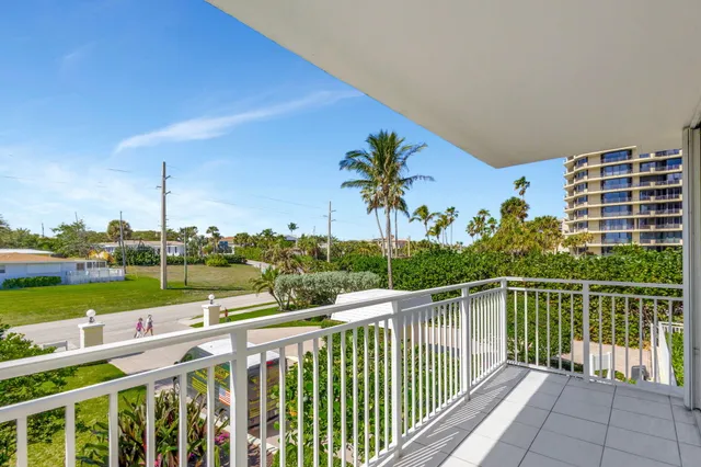 a living room with furniture a rug and a bookshelf