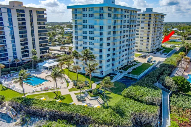 an aerial view of a house with a garden and swimming pool