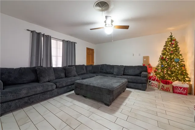 a living room with furniture and a christmas tree