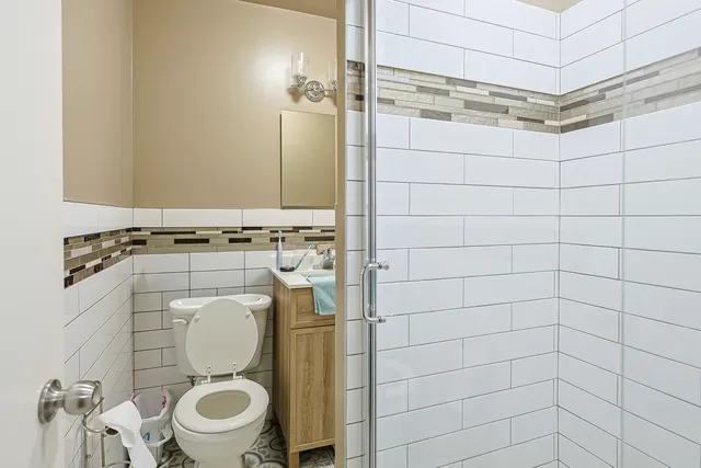 a bathroom with a toilet and a shower
