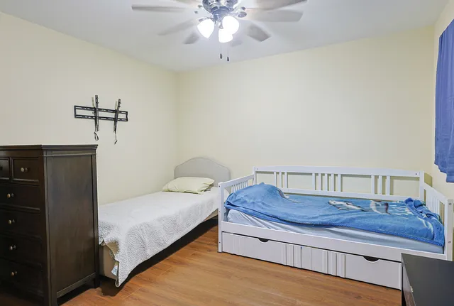 a bedroom with a bed and cabinet