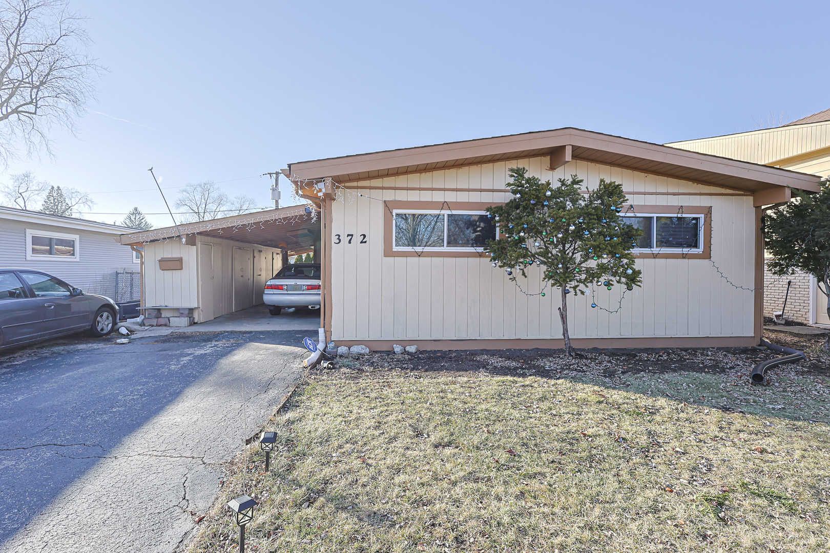 372 Nancy Lane Wheeling, IL 60090 - Photo 2 of 28 a front view of a house with a yard