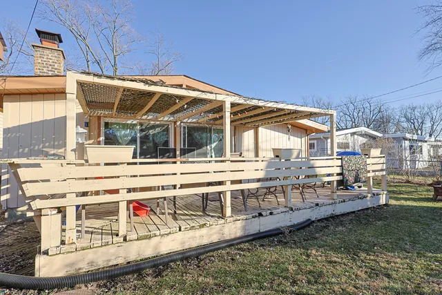 a view of a house with a wooden deck