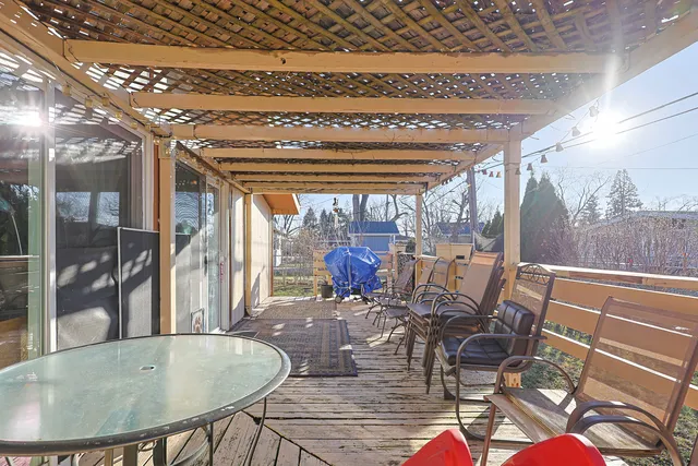 a view of a dining room with furniture wooden floor and chandelier