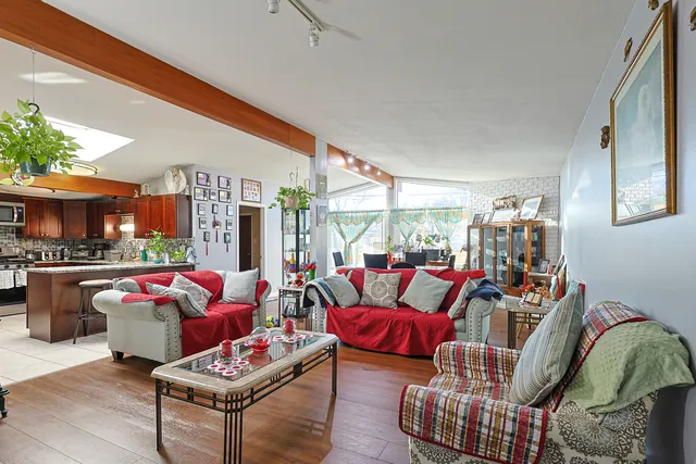 a living room with furniture fireplace and a large window