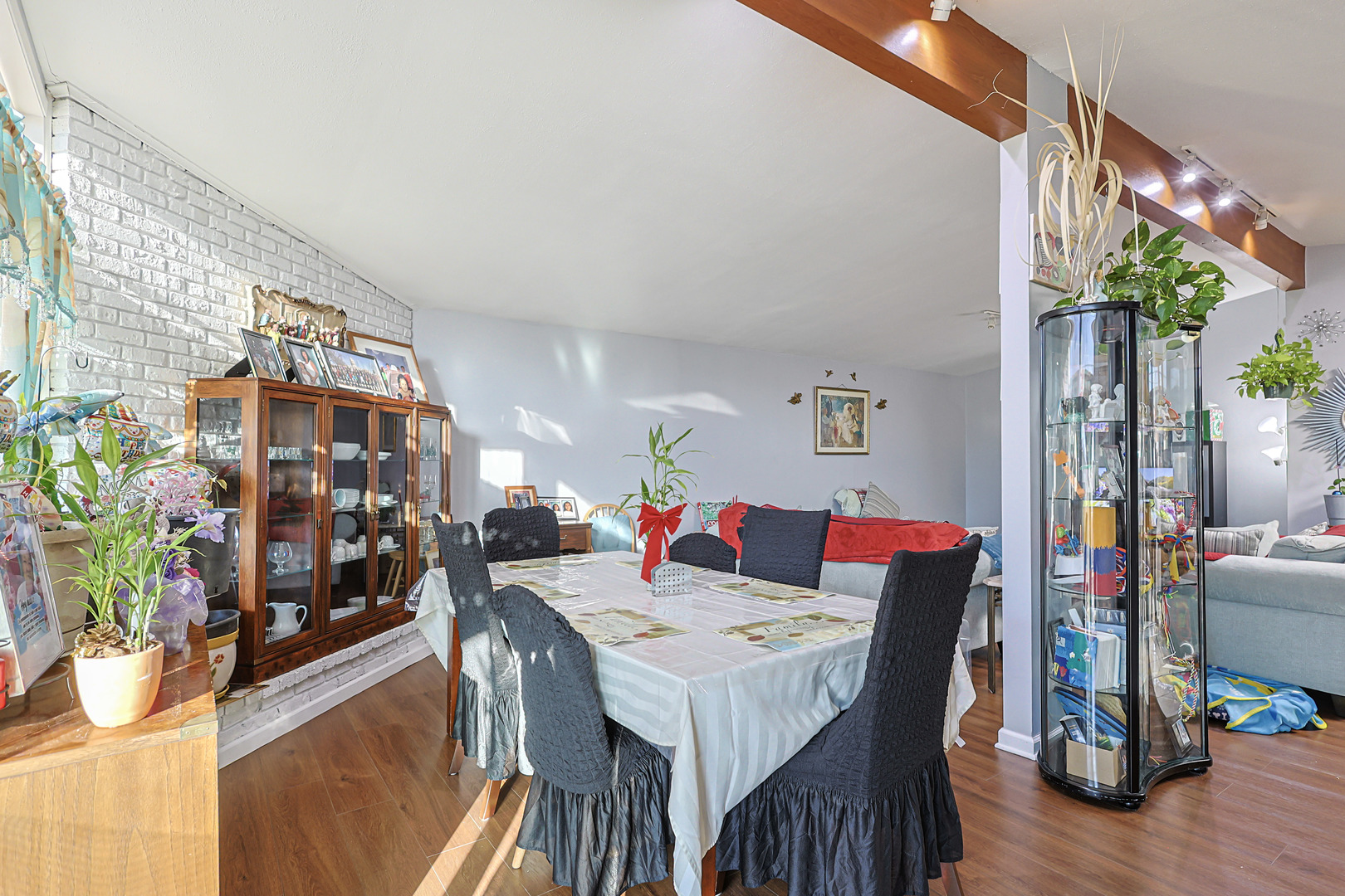 372 Nancy Lane Wheeling, IL 60090 - Photo 5 of 28 a view of a dining room with furniture a potted plant and wooden floor