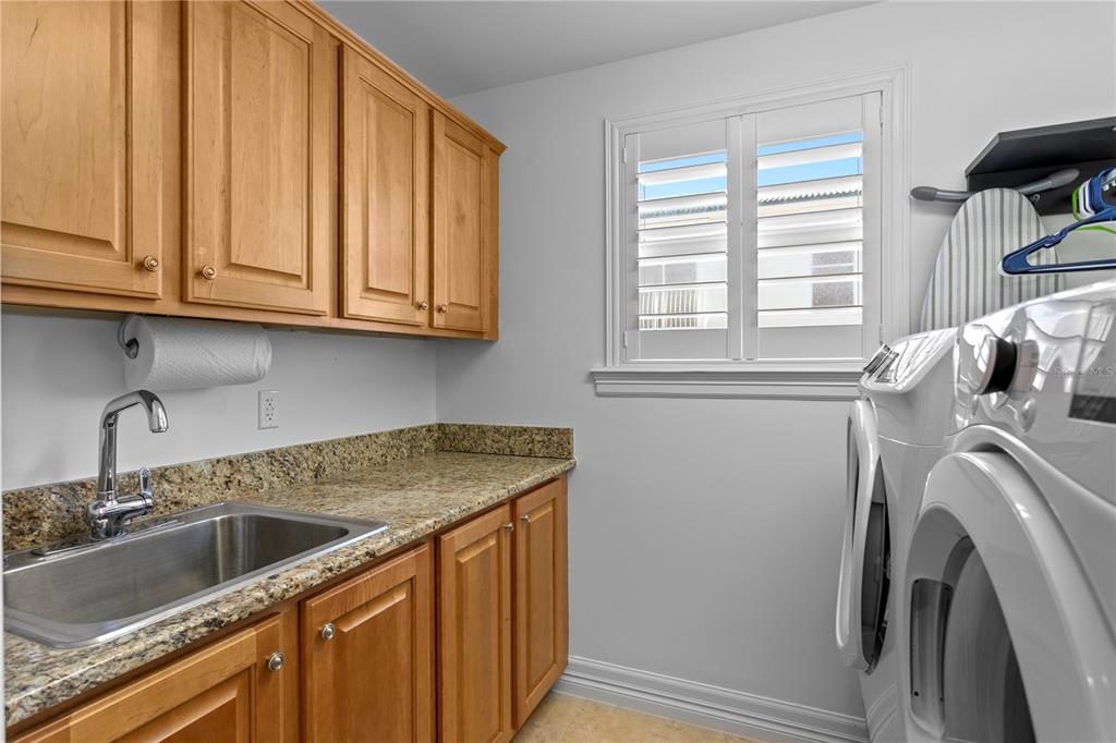 19730 Gulf Boulevard, Unit 400 Indian Rocks Beach, FL 33785 - Photo 52 of 90 a view of a sink and washer dryer