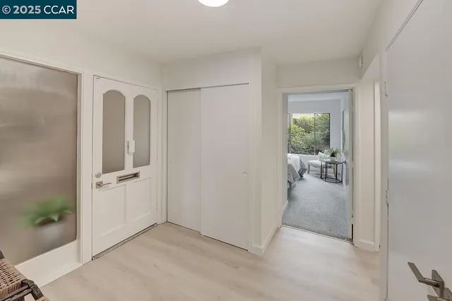 a view of a livingroom with wooden floor a glass door and a living room