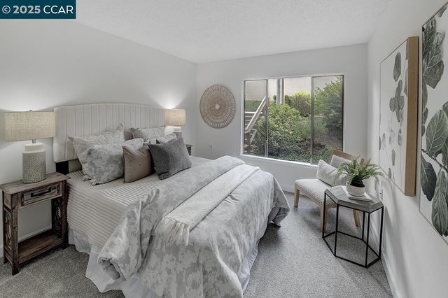 a bedroom with a bed and a large window