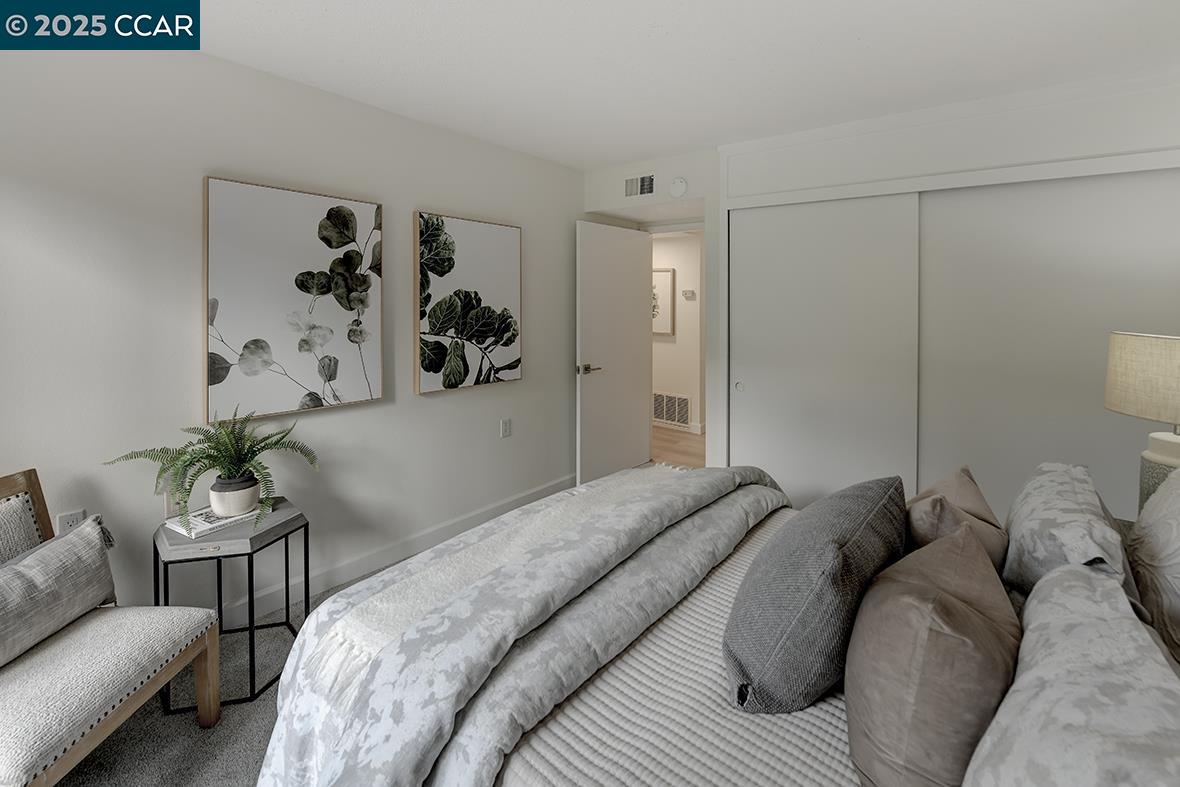 2940 Tice Creek Drive, Unit 6 Walnut Creek, CA 94595 - Photo 24 of 49 a bed room with a bed and a couch