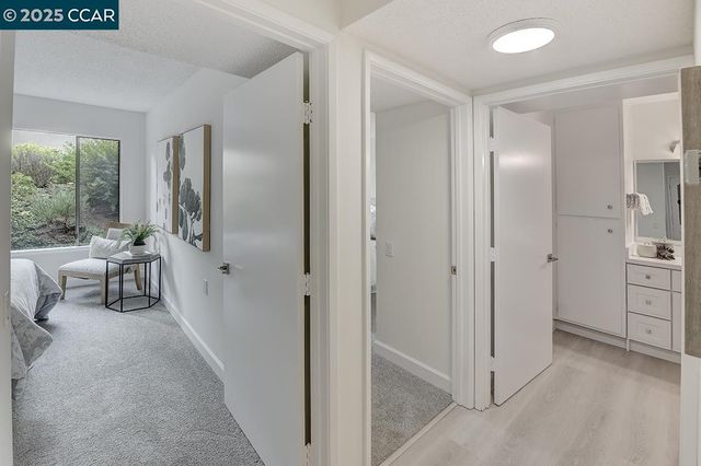 a view of a livingroom with a chair and front door