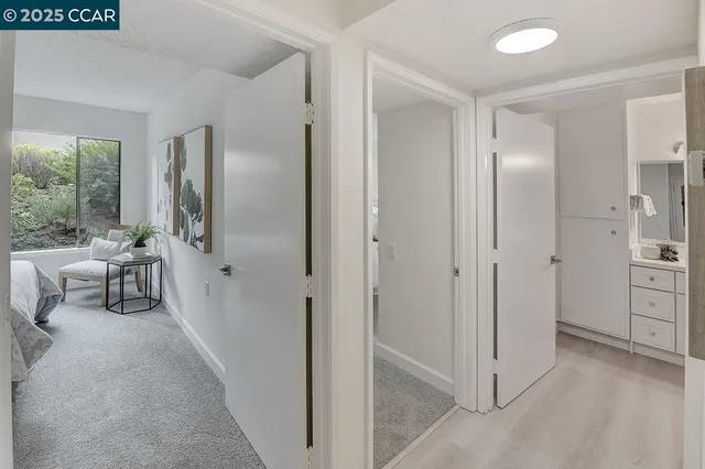 a view of a livingroom with a chair and front door
