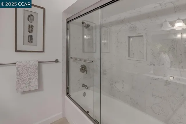 a bathroom with a bathtub and shower