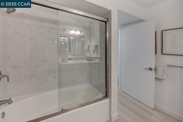 a bathroom with a glass shower door