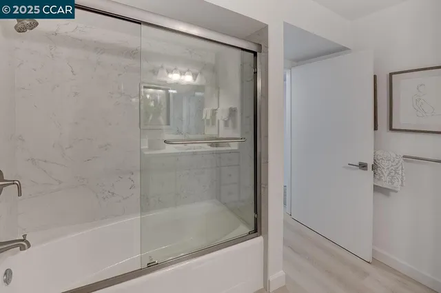 a bathroom with a glass shower door