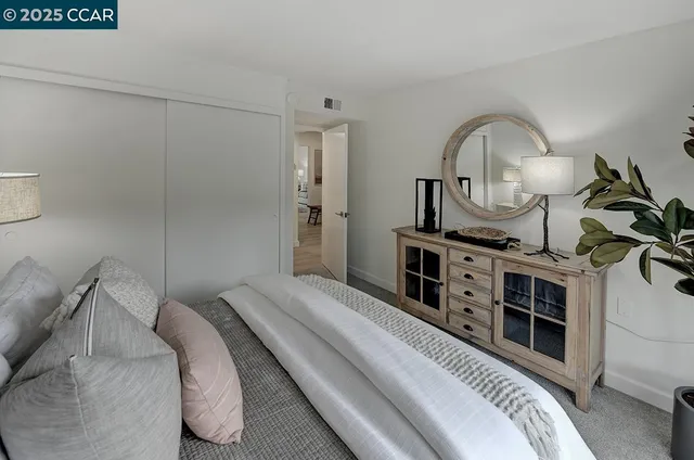 a bedroom with a bed and a dresser