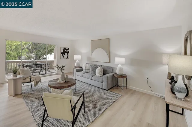 a living room with furniture a lamp and a table