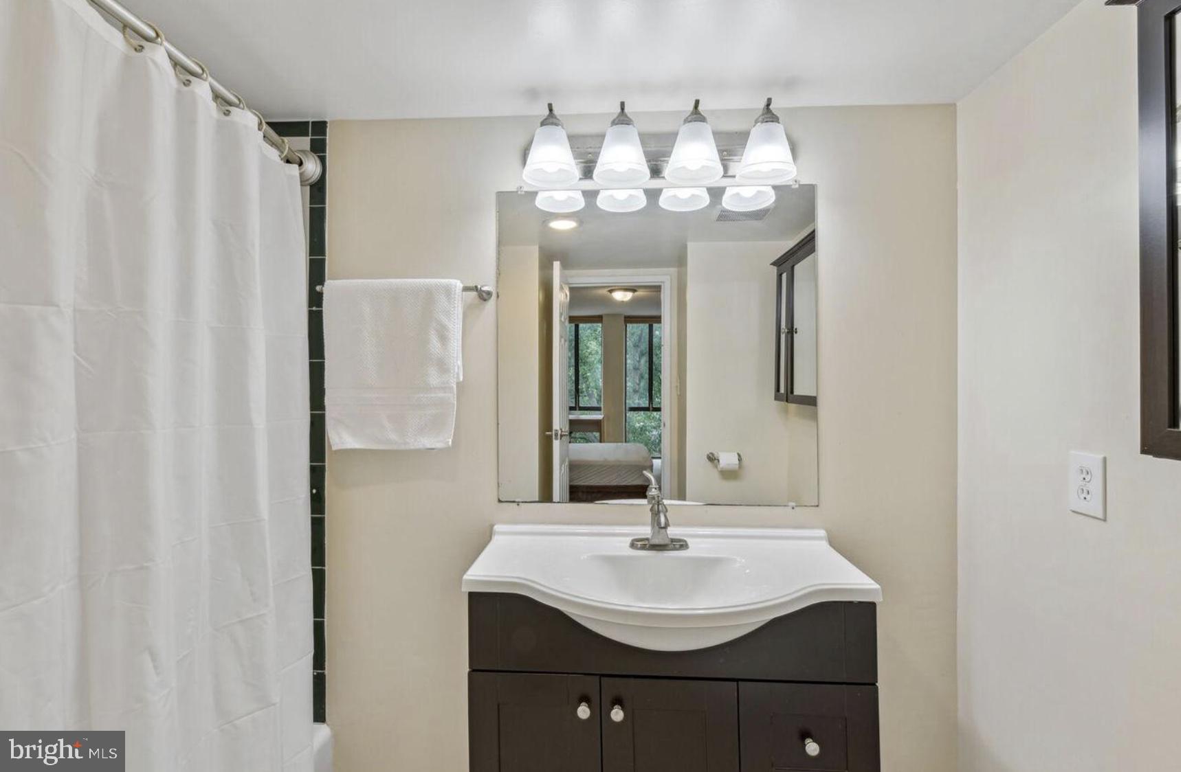 1401 North Rhodes Street, Unit 406 Arlington, VA 22209 - Photo 9 of 14 Modern bathroom with elegant fixtures.