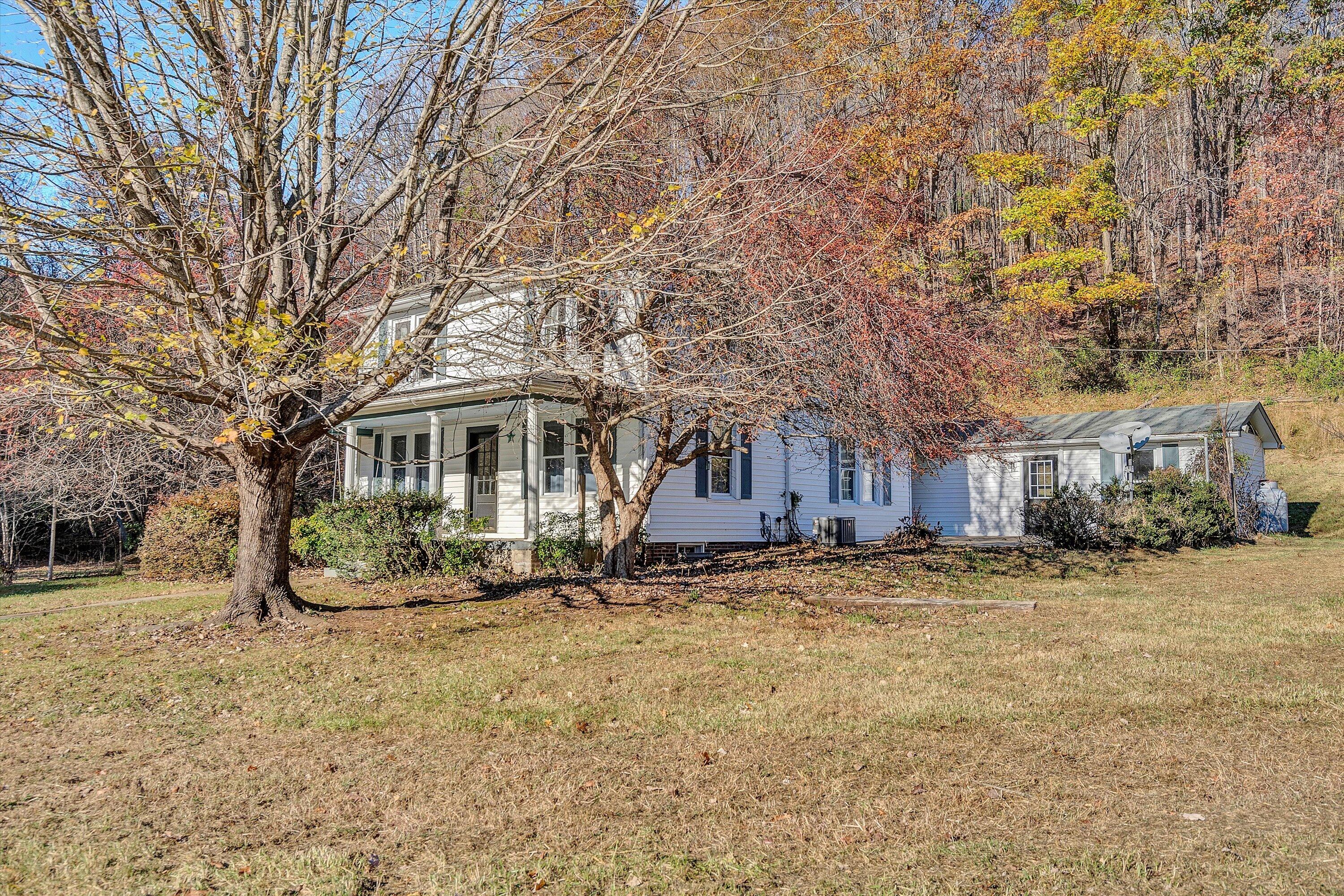 a front view of a house with a yard covered with snow
