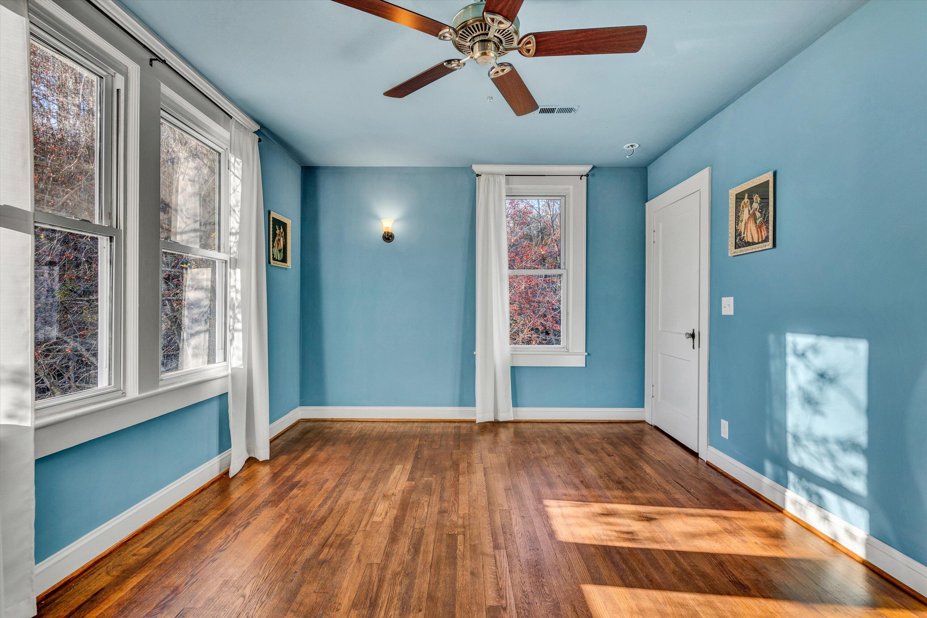 370 Rustic Ridge Road Stuart, VA 24171 - Photo 22 of 42 a view of an empty room with wooden floor and a window