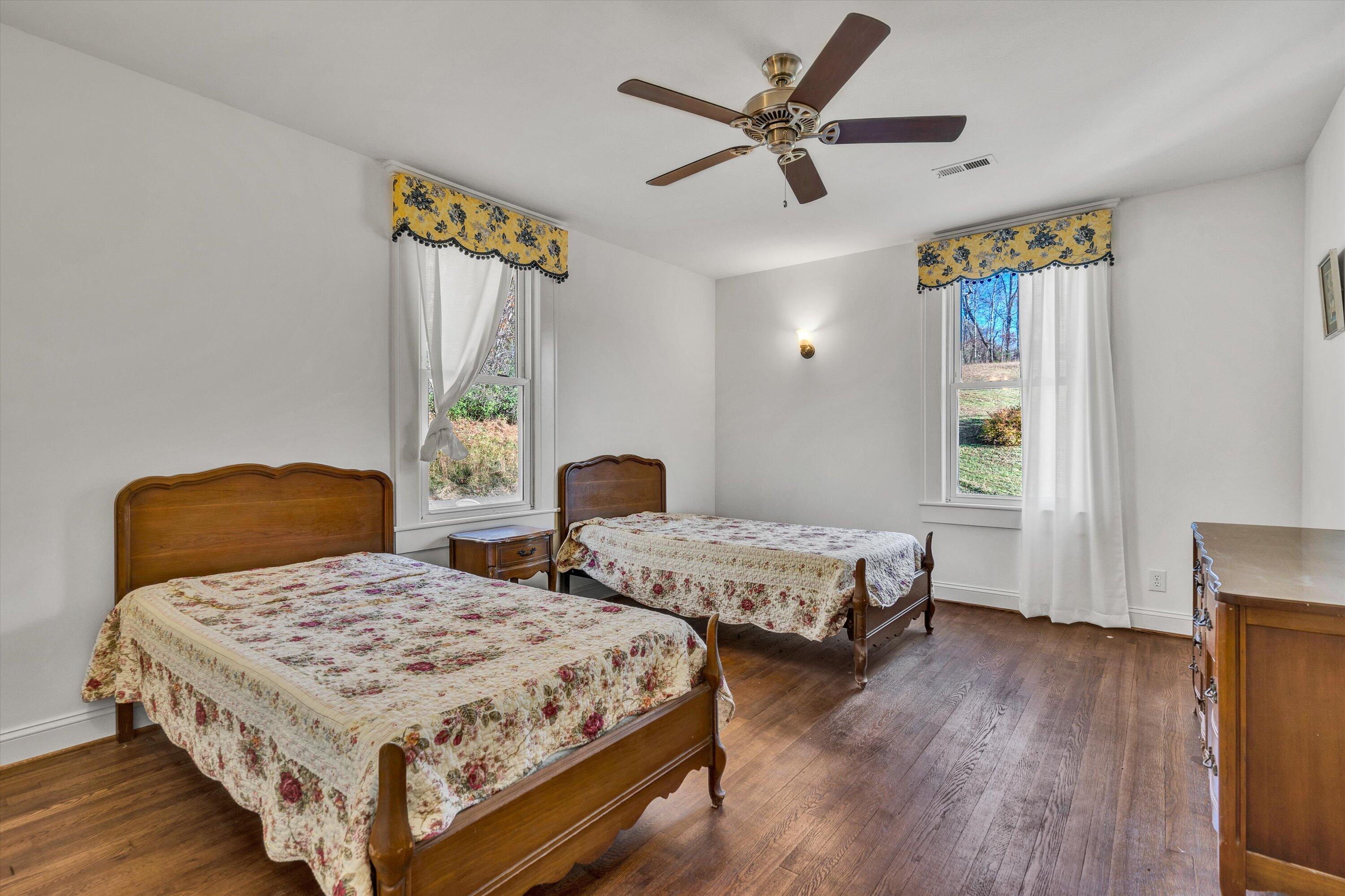 370 Rustic Ridge Road Stuart, VA 24171 - Photo 23 of 42 a bedroom with a bed and wooden floor