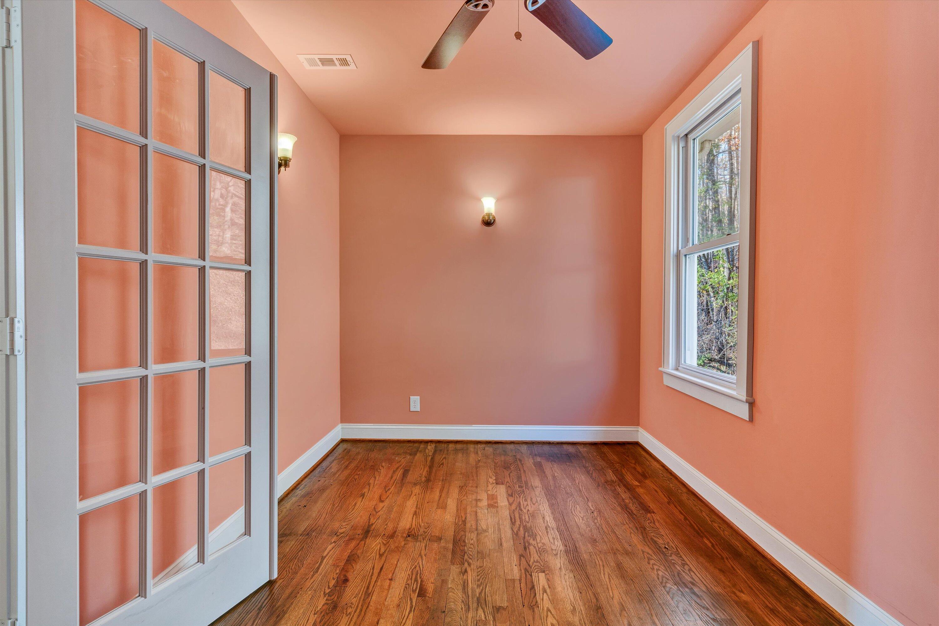 370 Rustic Ridge Road Stuart, VA 24171 - Photo 24 of 42 an empty room with wooden floor and windows