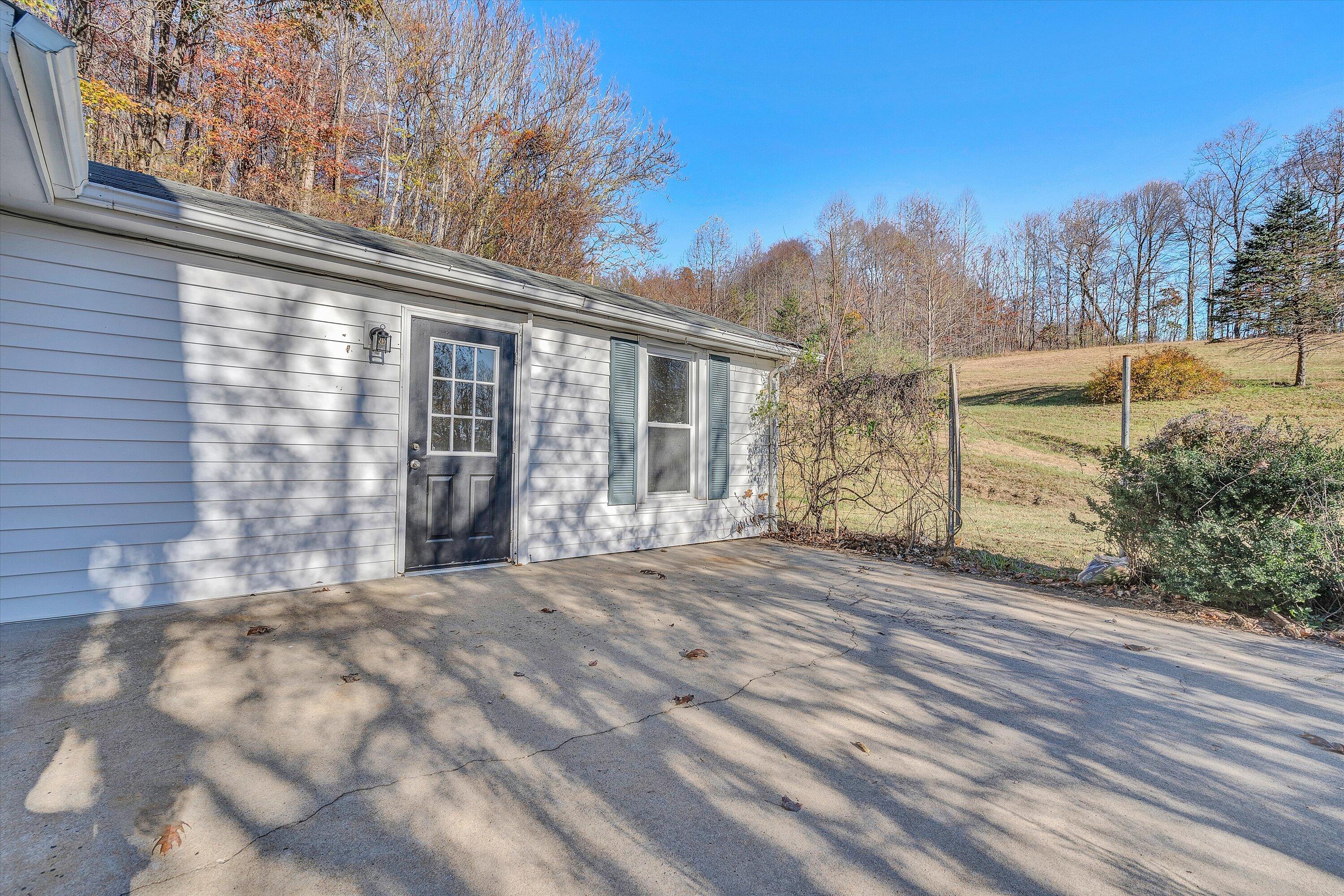 370 Rustic Ridge Road Stuart, VA 24171 - Photo 27 of 42 a view of a house with a yard