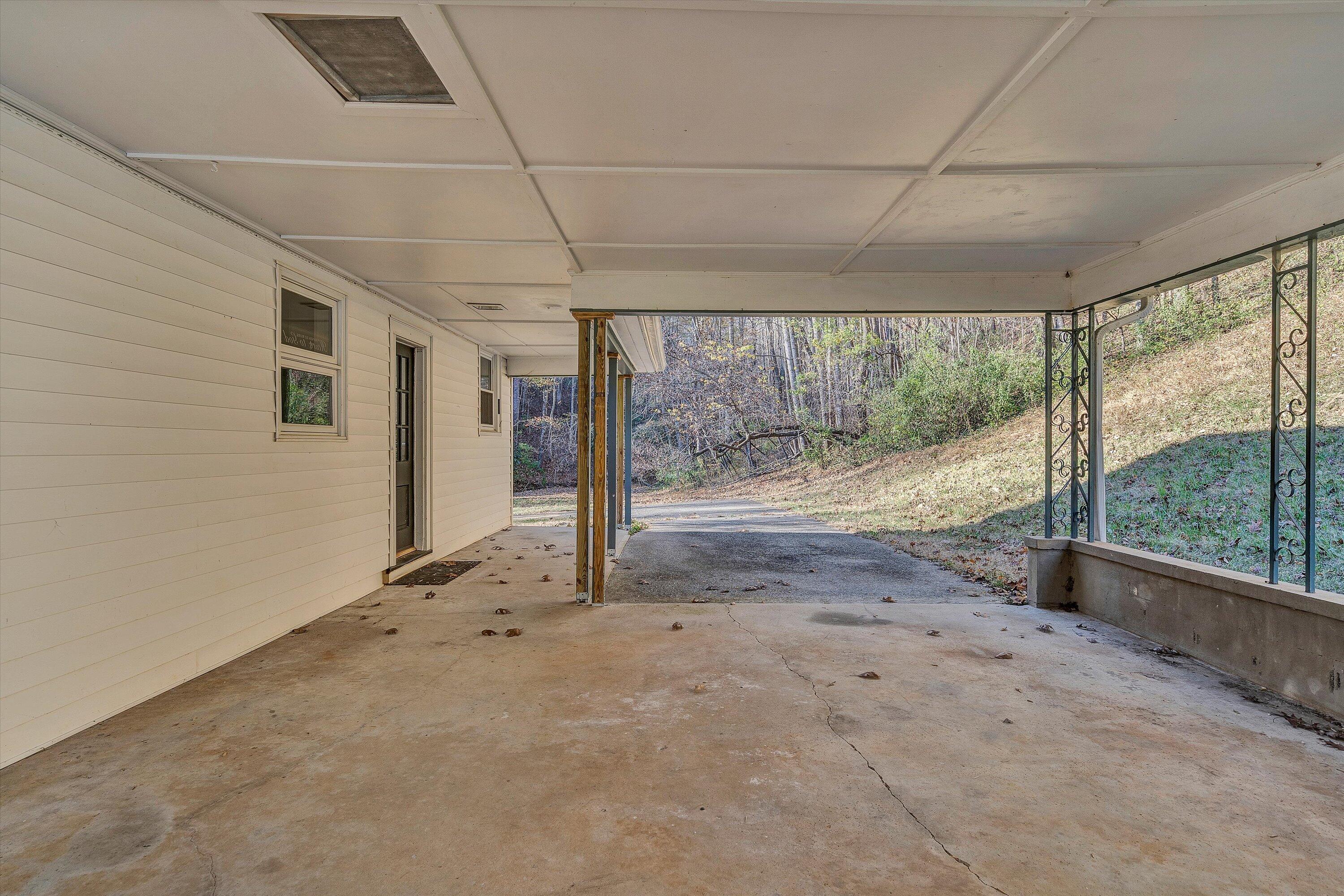 370 Rustic Ridge Road Stuart, VA 24171 - Photo 34 of 42 a view of an empty room with wooden floor and a window