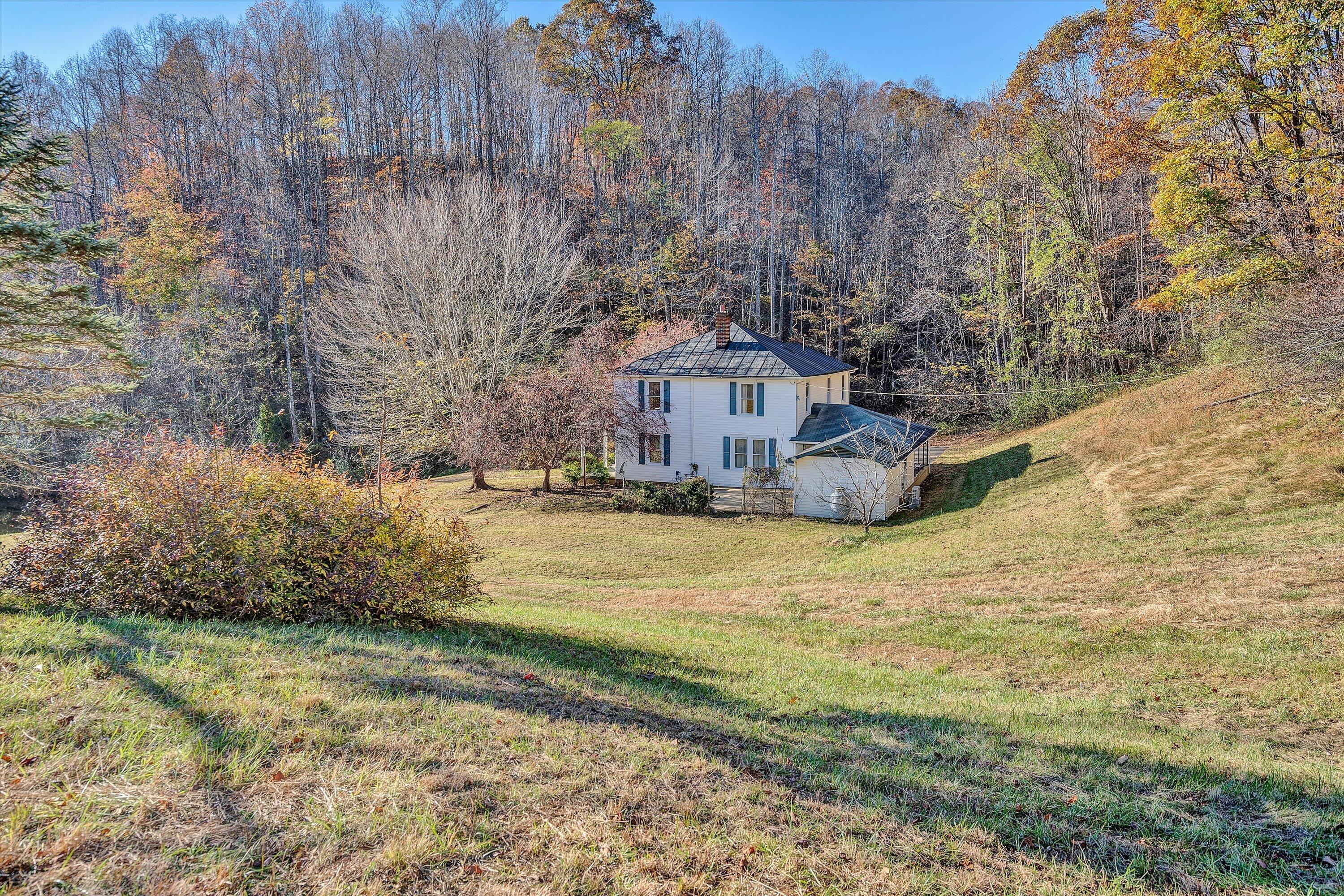 370 Rustic Ridge Road Stuart, VA 24171 - Photo 38 of 42 a house with trees in front of it