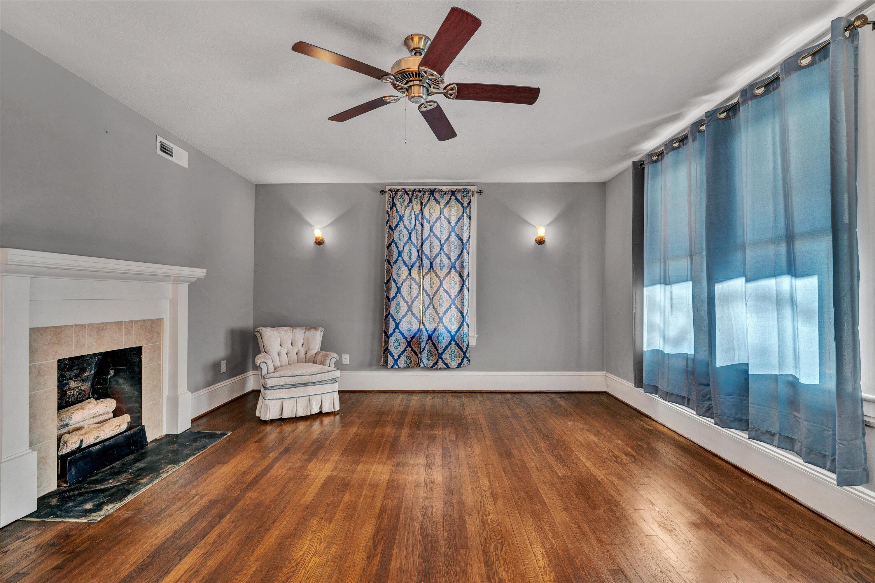370 Rustic Ridge Road Stuart, VA 24171 - Photo 7 of 42 a living room with wooden floor and a fireplace