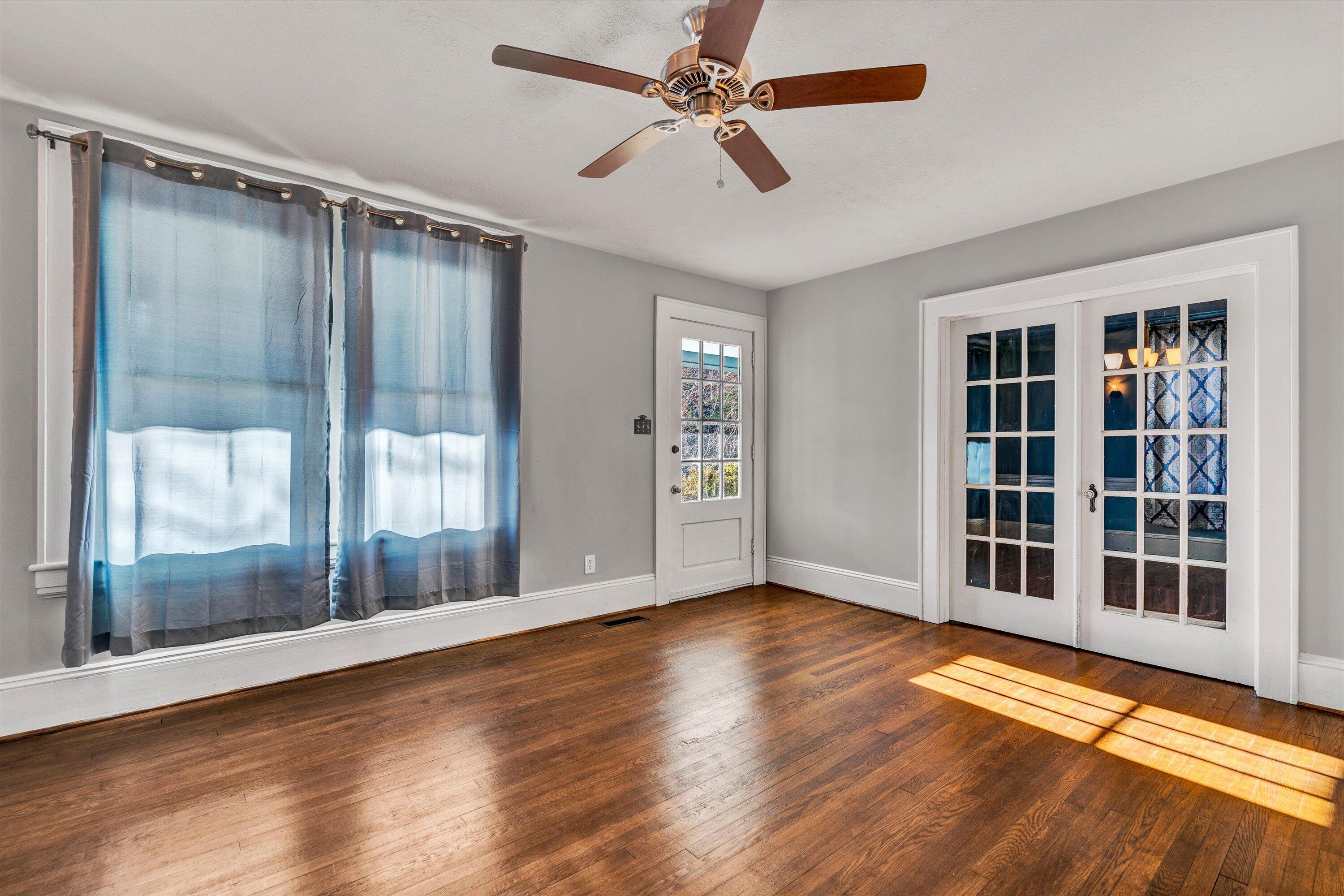 370 Rustic Ridge Road Stuart, VA 24171 - Photo 9 of 42 a view of empty room with wooden floor and fan