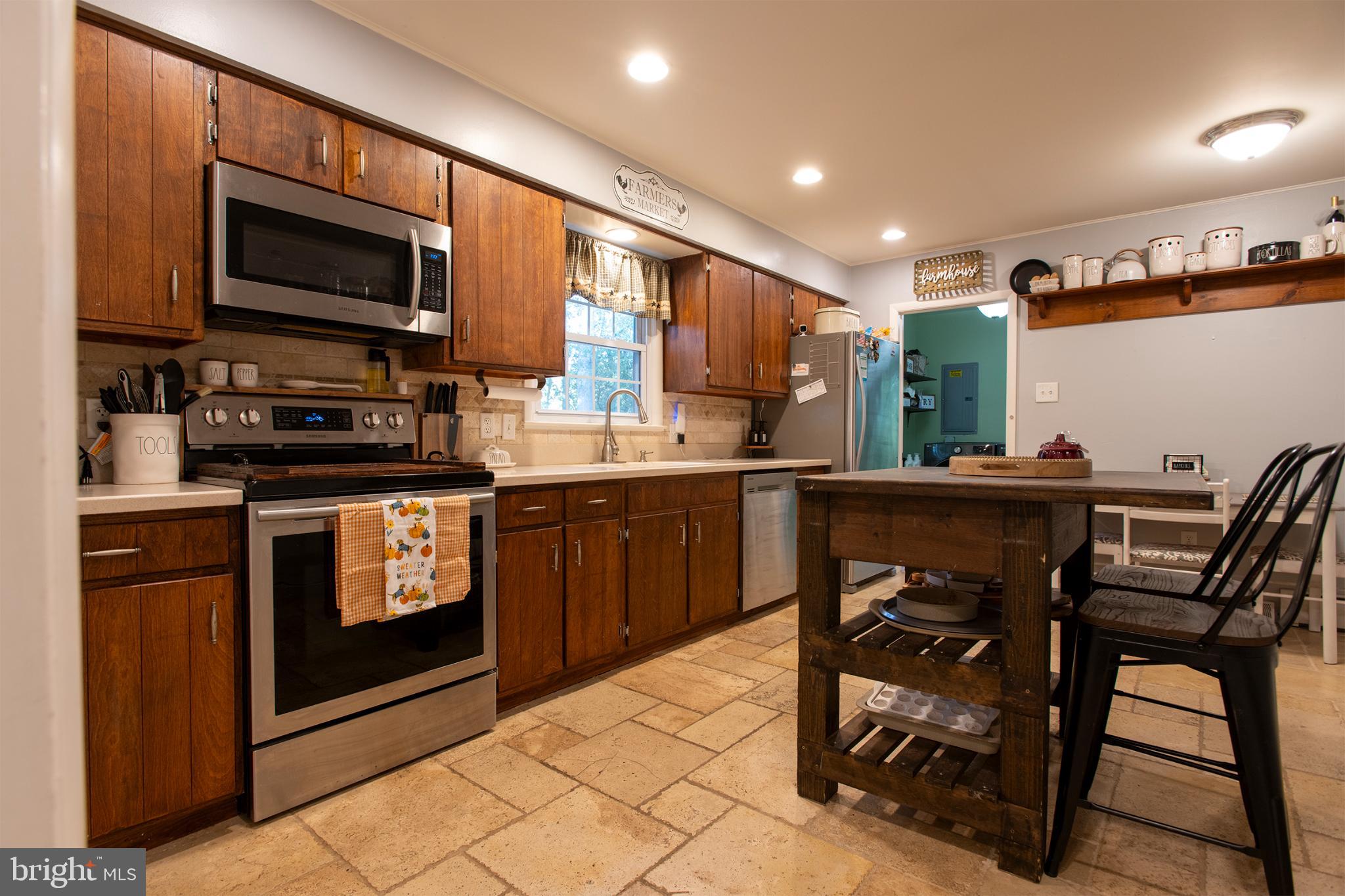 32 Ohio Trail Medford, NJ 08055 - Photo 7 of 25 a kitchen with stainless steel appliances kitchen island granite countertop a stove a sink and a microwave