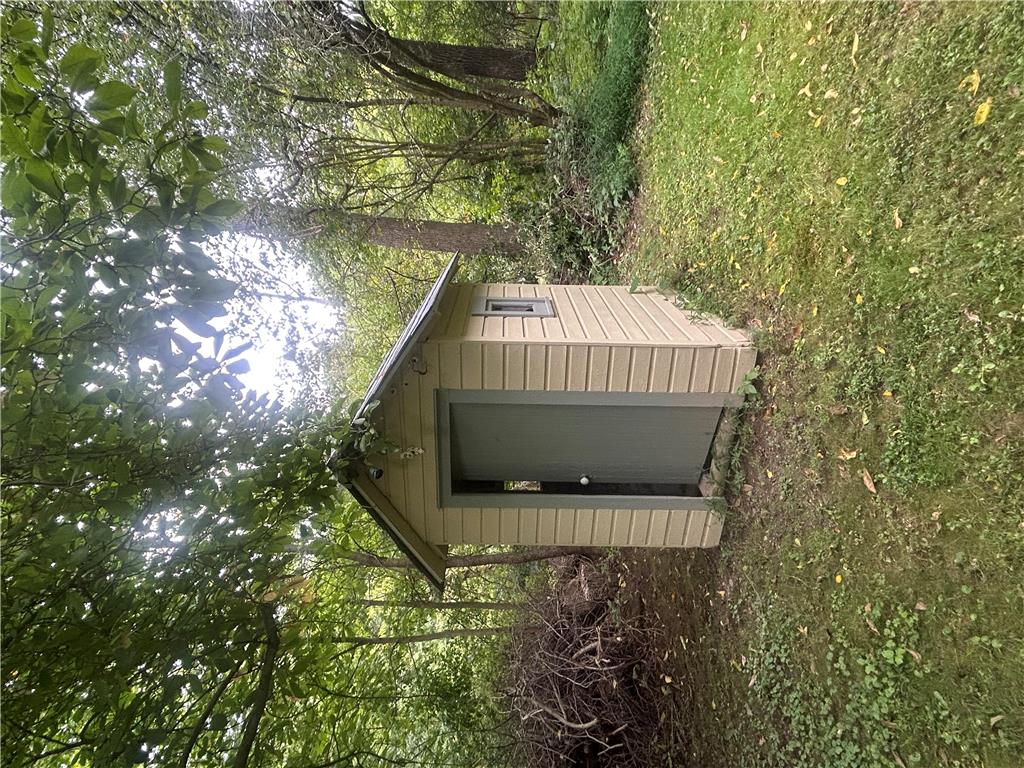 7 Allegheny Road Mount Bethel, PA 18343 - Photo 14 of 71 A practical storage shed stands nestled along the quiet wooded edge of the property.