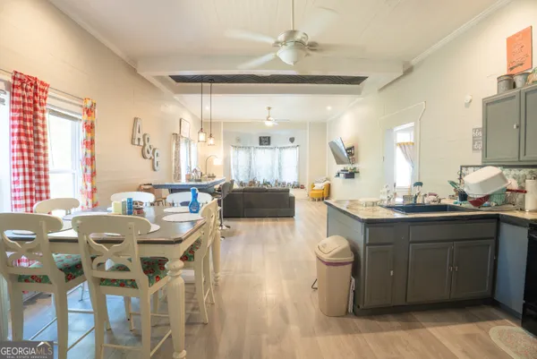 a large kitchen with a table and chairs