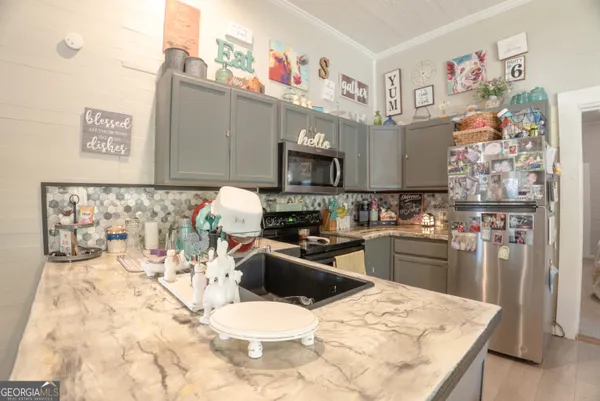 a kitchen with stainless steel appliances kitchen island granite countertop a sink and cabinets