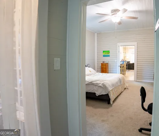 a bed sitting in a bedroom next to a window