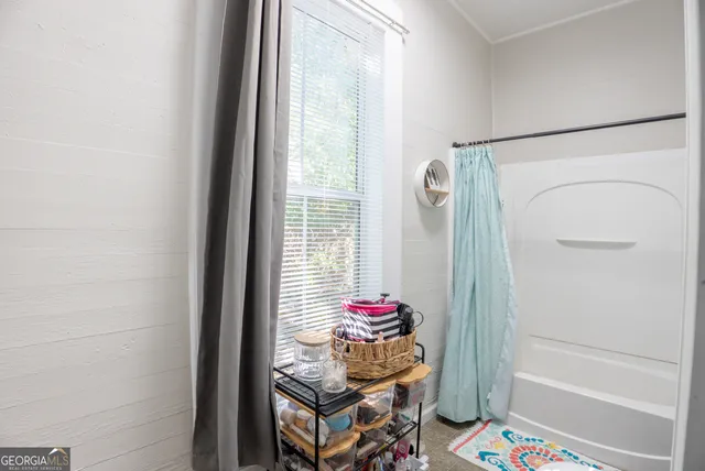 a room that has a bed and a table in it