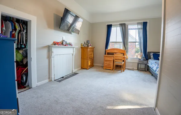 a view of a livingroom with furniture and a flat screen tv