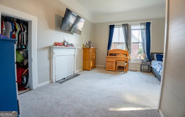 a view of a livingroom with furniture and a flat screen tv