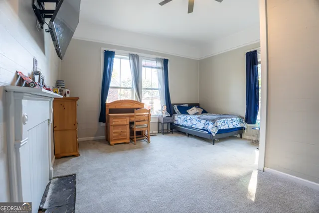 a bedroom with bed and a window