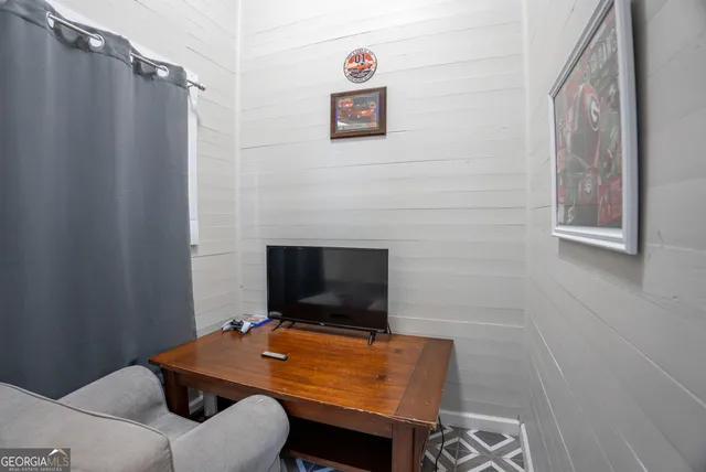 a room with furniture and a flat screen tv